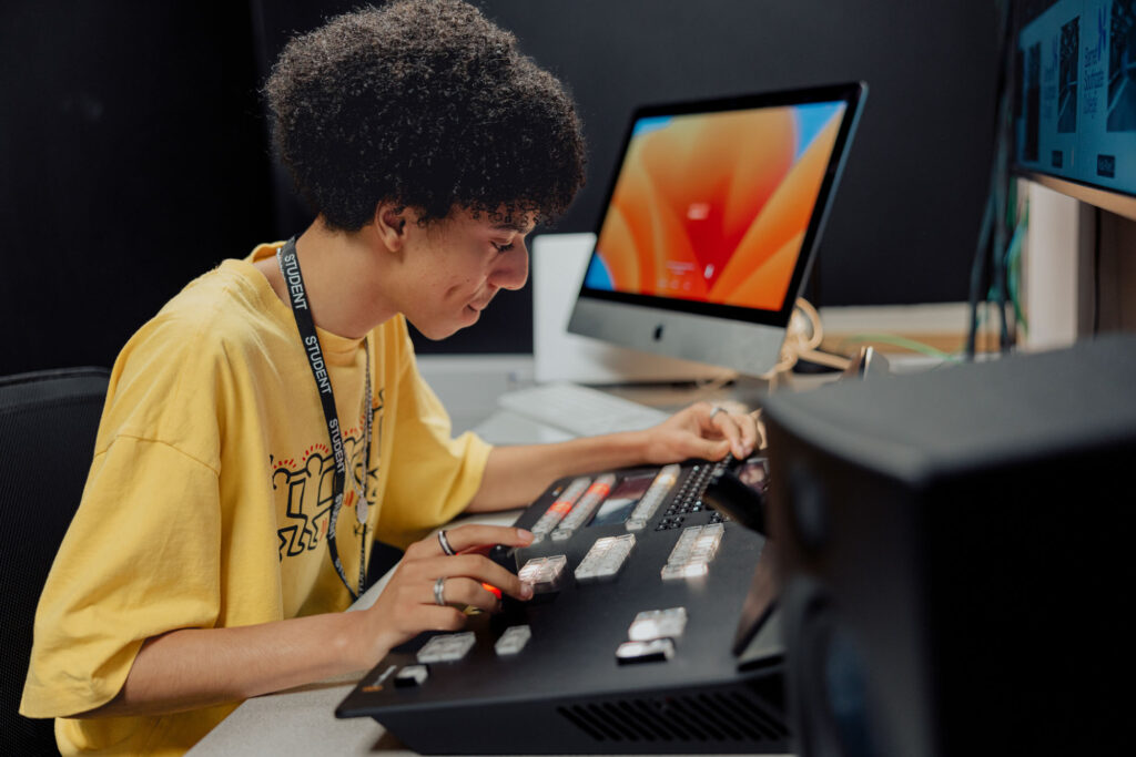 Student working in the Studio with editing equipment.