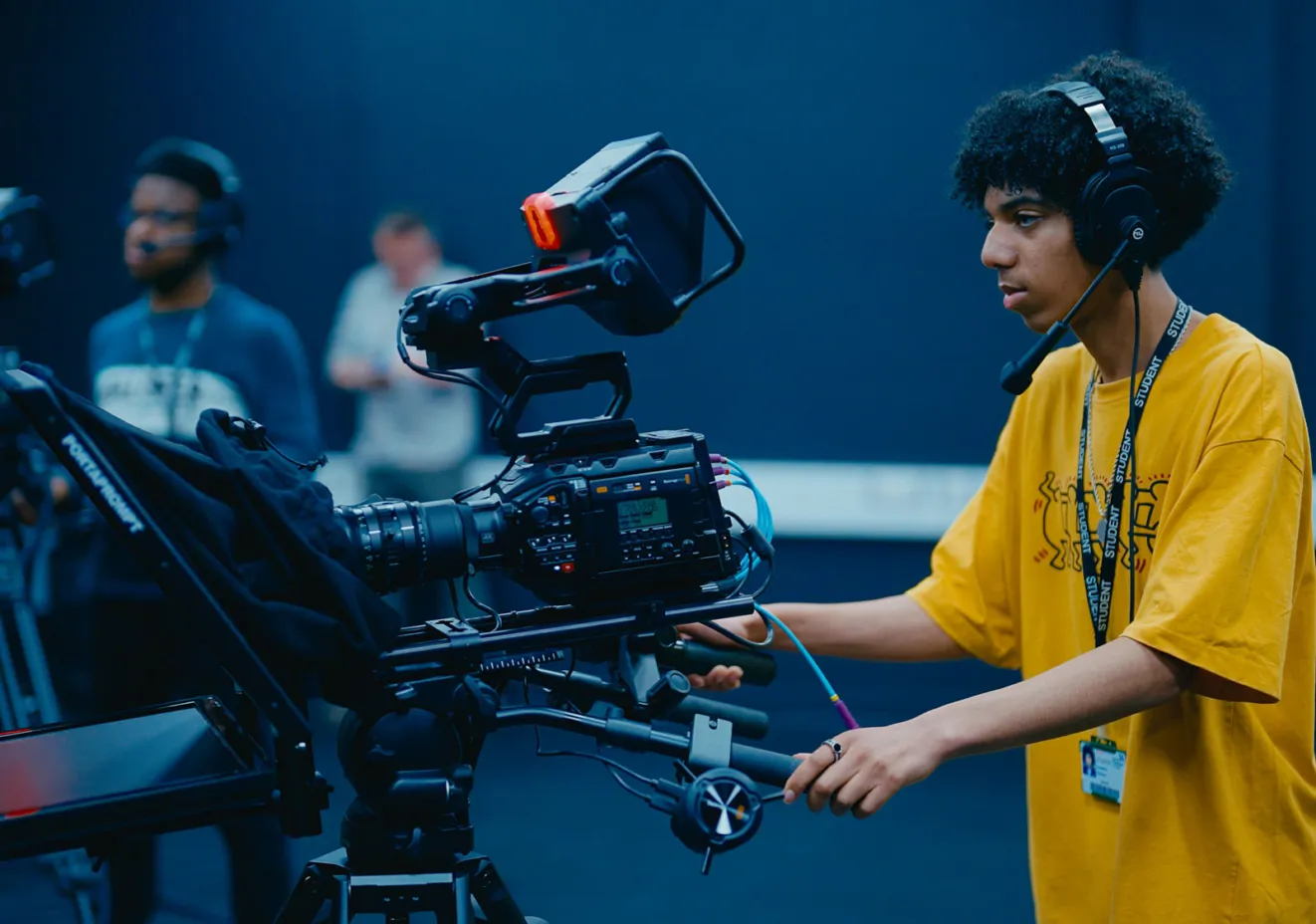 Student operating studio television camera.