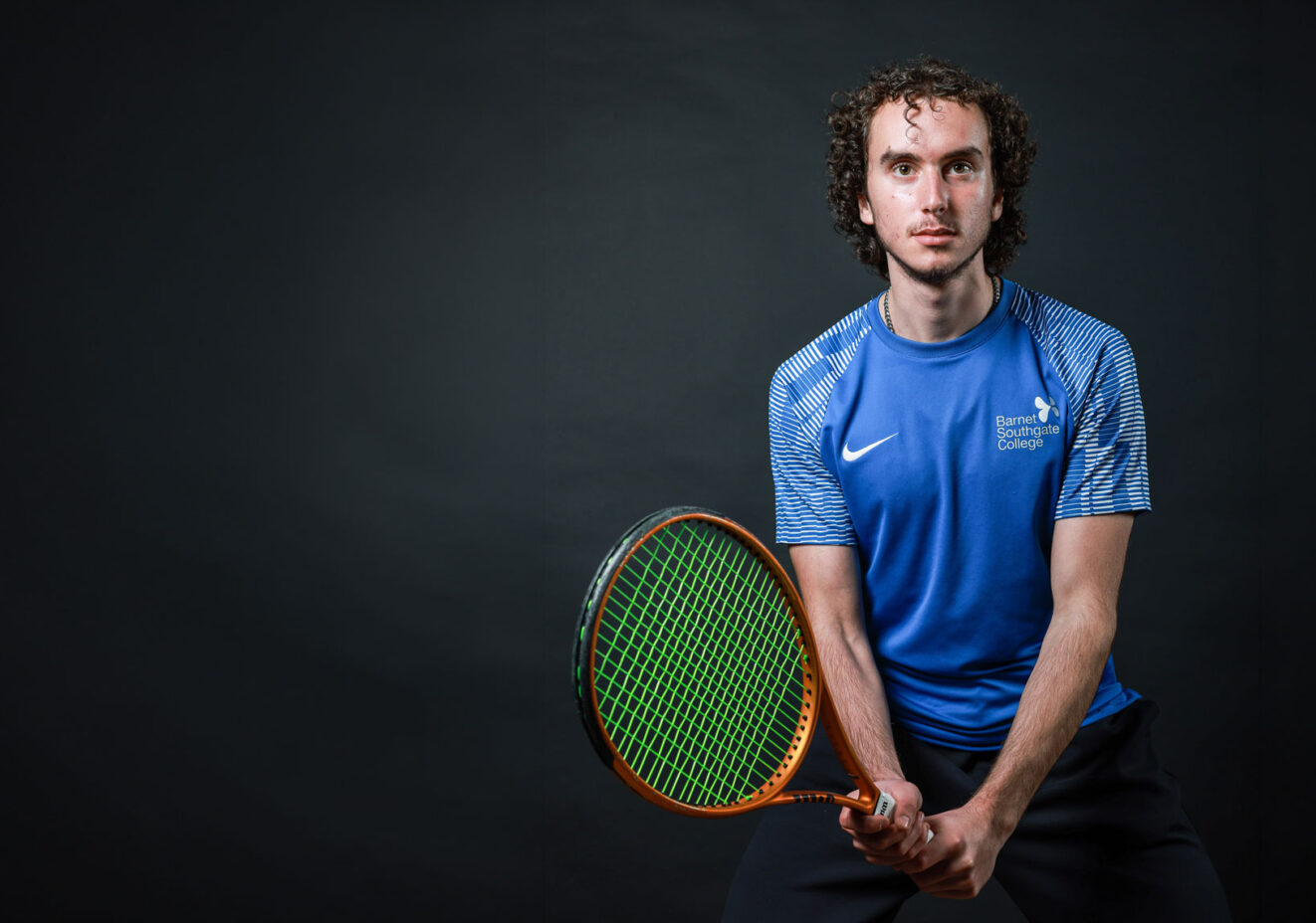 Tennis player holding tennis racquet.