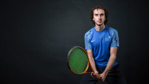 Tennis player holding tennis racquet.
