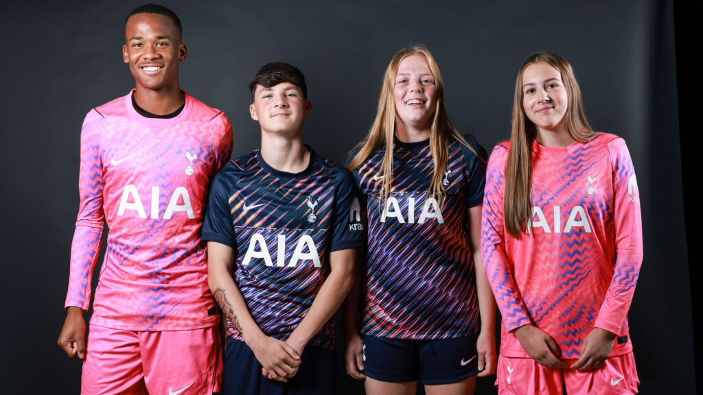 Sports students smiling at camera, dressed in Barnet and Southgate football kit.